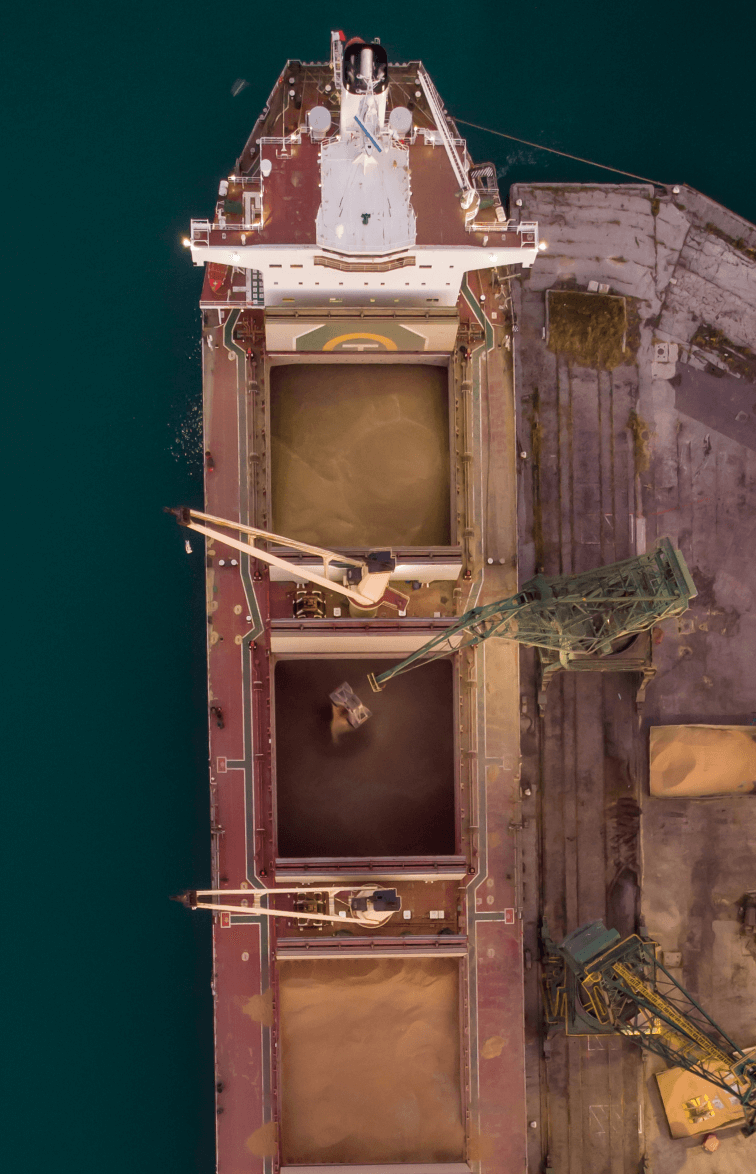 aerial-view-of-big-cargo-ship-bulk-carrier-is-load-2023-11-27-04-49-17-utc-1